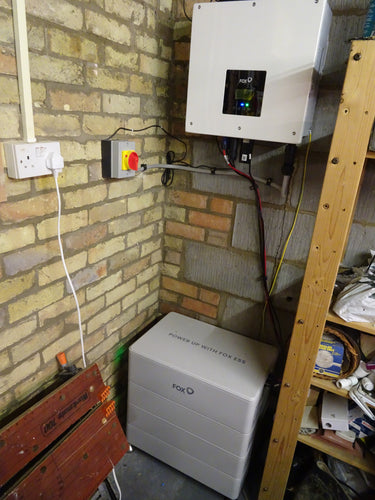 Fox ESS 5kw AC charger with Cube batteries installed on brick wall.